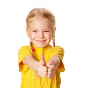 Smiling girl showing thumbs up or OK symbol.
