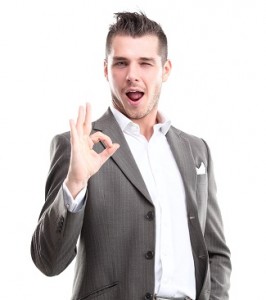 Happy smiling young business man with thumbs up gesture