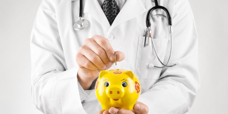 Doctor trying to put coin into yellow piggy bank