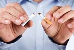 Quit smoking,   human hands breaking up cigarette