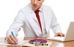 A male doctor working at desk,   isolated on white background