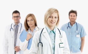 Team of young medical doctors smiling at camera,   isolated on white.