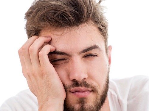 Sleepy young man does not want to wake up early in the morning