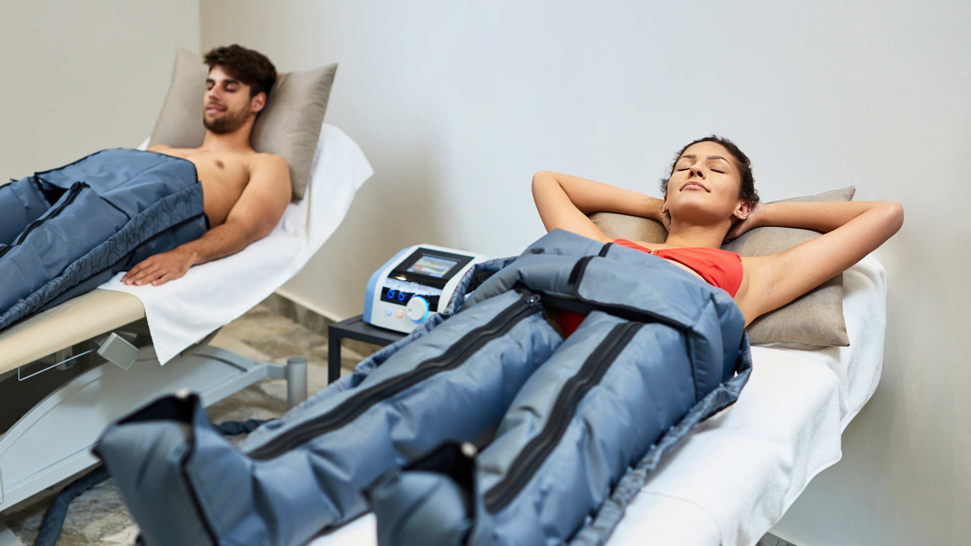 mujer-relajada-su-novio-disfrutando-presoterapia-centro-bienestar